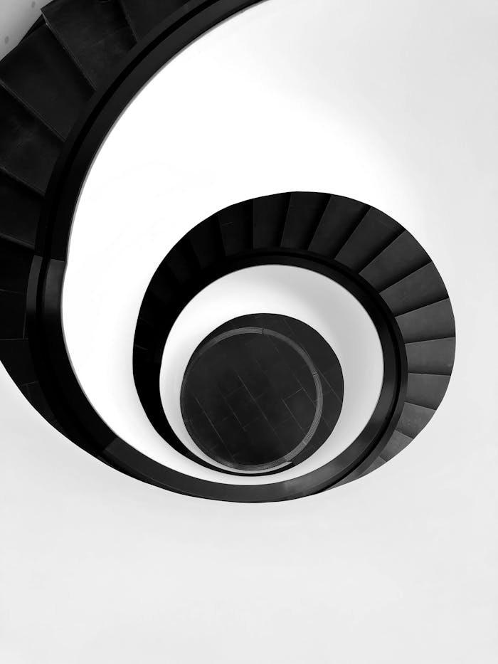 gallery-3 Black and white abstract of a spiral staircase in Nürnberg, Germany showcasing minimalism and modern architecture.